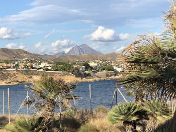 Scenic view of sea and mountains against sky