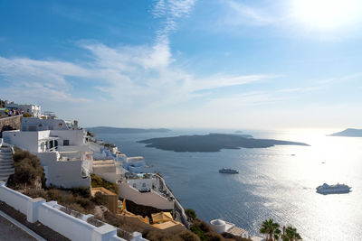 High angle view of buildings by sea against sky