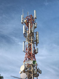 Low angle view of communications tower against sky