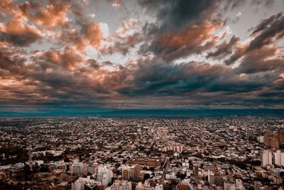 Aerial view of buildings against dramatic sky