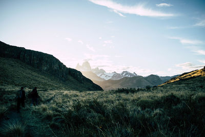 Scenic view of field against sky with snowcapped mountain