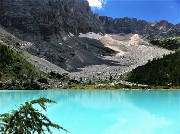 Scenic view of lake and mountains against blue sky