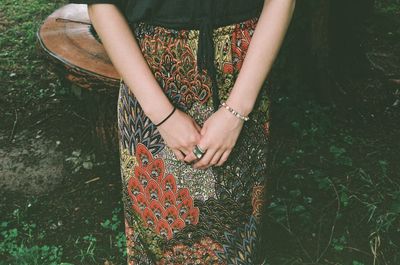 Midsection of woman standing on field