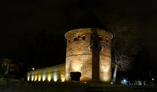 Low angle view of illuminated building against sky at night