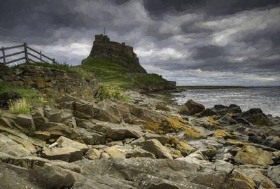 Scenic view of rocks on beach against sky