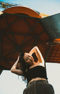 Low angle portrait of young woman outdoors