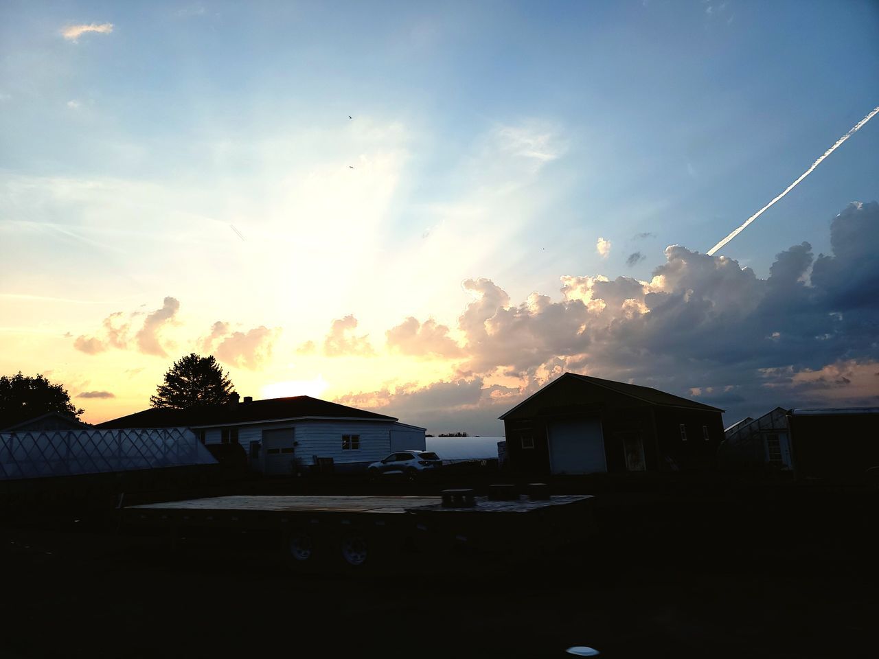 sky, architecture, cloud, built structure, sunlight, house, building exterior, sunset, building, dusk, evening, nature, sun, residential district, horizon, no people, city, light, outdoors, beauty in nature, silhouette, blue, afterglow, scenics - nature, landscape