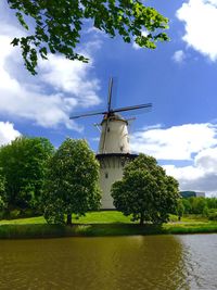 Traditional windmill against cloudy sky