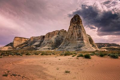 Rock formations against cloudy sky