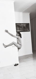 Side view of woman standing on tiled floor