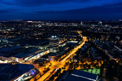 High angle view of illuminated cityscape against sky at night