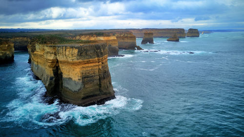 Scenic view of rock formation in sea against sky