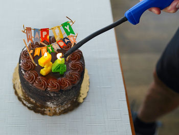 Midsection of person holding cake