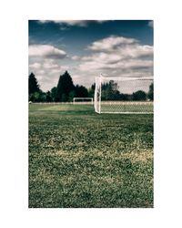 View of soccer field against cloudy sky