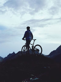 Young man on a bike tour in the mountains