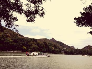 People in boat against sky