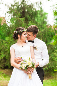 Side view of bride holding bouquet