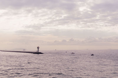 Boat sailing in sea against sky