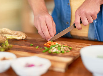 Midsection of man preparing food on table
