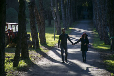 People walking on street amidst trees