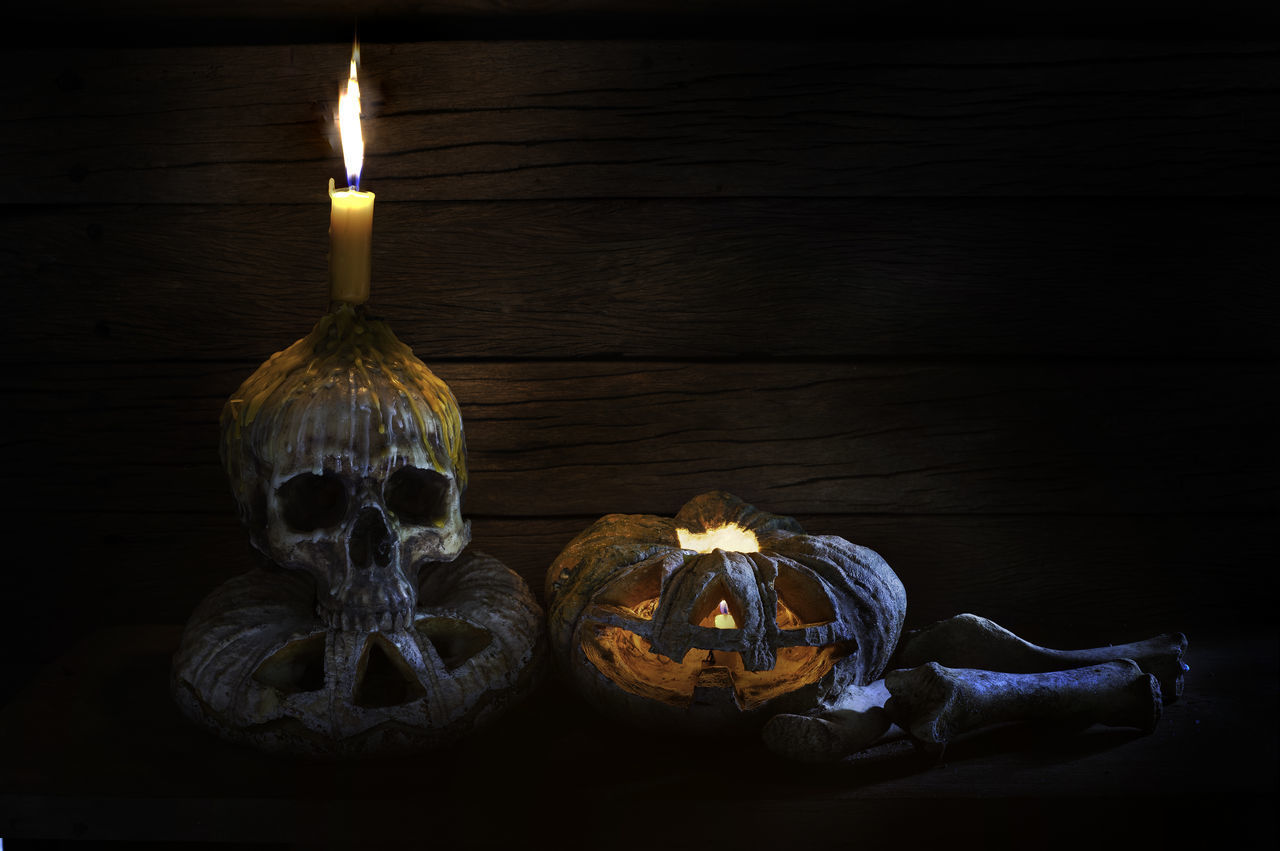 CLOSE-UP OF CANDLES ON WOODEN TABLE