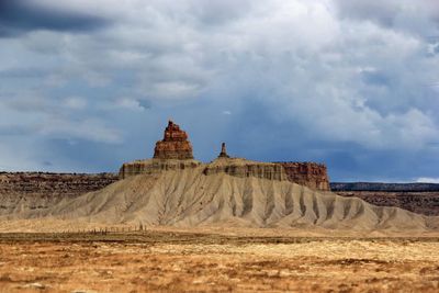 Scenic view of rock formation against cloudy sky