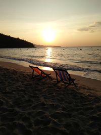 Scenic view of beach against sky during sunset