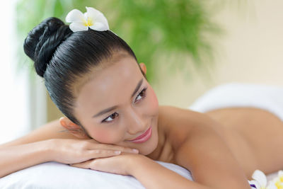 Topless young woman relaxing at spa