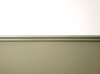 Low angle view of wall against white background