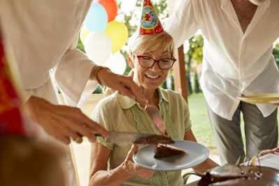 Serving cake on a birthday garden party