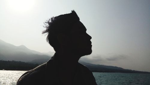 Portrait of young man against sky