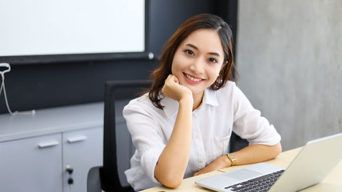 Young businesswoman using laptop while sitting in car