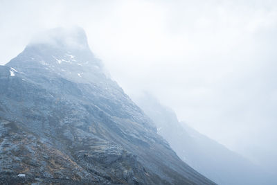 Jagged mountain peak with misty top and background. norway.