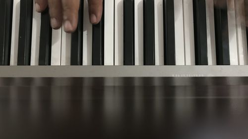 Close-up of man playing piano