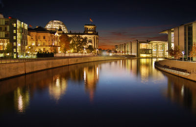 Reflection of illuminated buildings in city at night