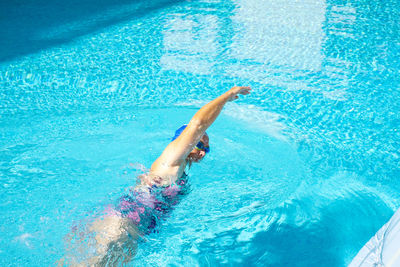 High angle view of woman swimming in pool