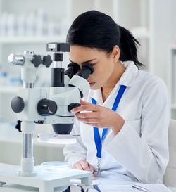 Side view of doctor examining patient in laboratory