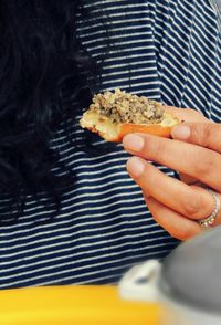 Close-up of cropped hand holding food