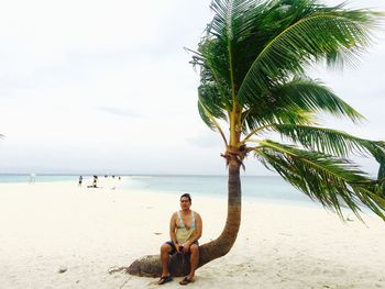 Full length of man sitting on beach