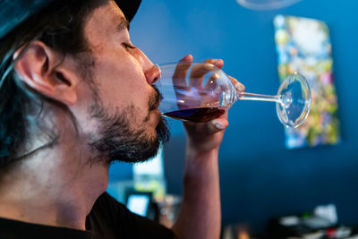 Close-up of man drinking wine