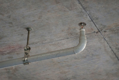 Grunge fire sprinkler or fire extinguishing system under building ceiling for emergency