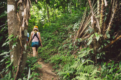 Full length of woman walking in forest