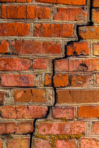 Full frame shot of brick wall with large diagonal crack