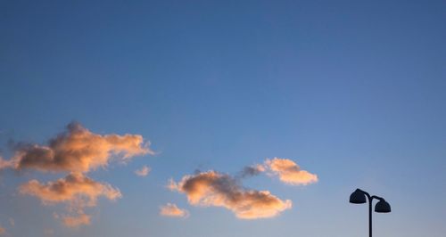 Low angle view of communications tower against sky during sunset