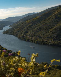 Scenic view of lake by mountains against sky