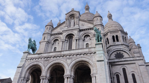 Low angle view of cathedral against cloudy sky