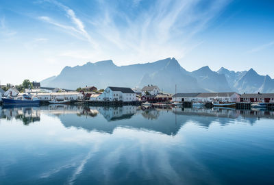 Scenic view of lake by mountains against sky