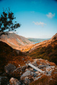 Scenic view of mountains against blue sky