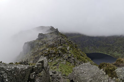 Coumshingaun corrie lake surrounded by fog covered ridges