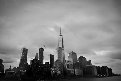 View of cityscape against cloudy sky